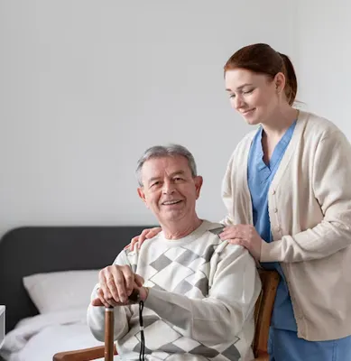 Care coordinator talking with older woman at desk in home office